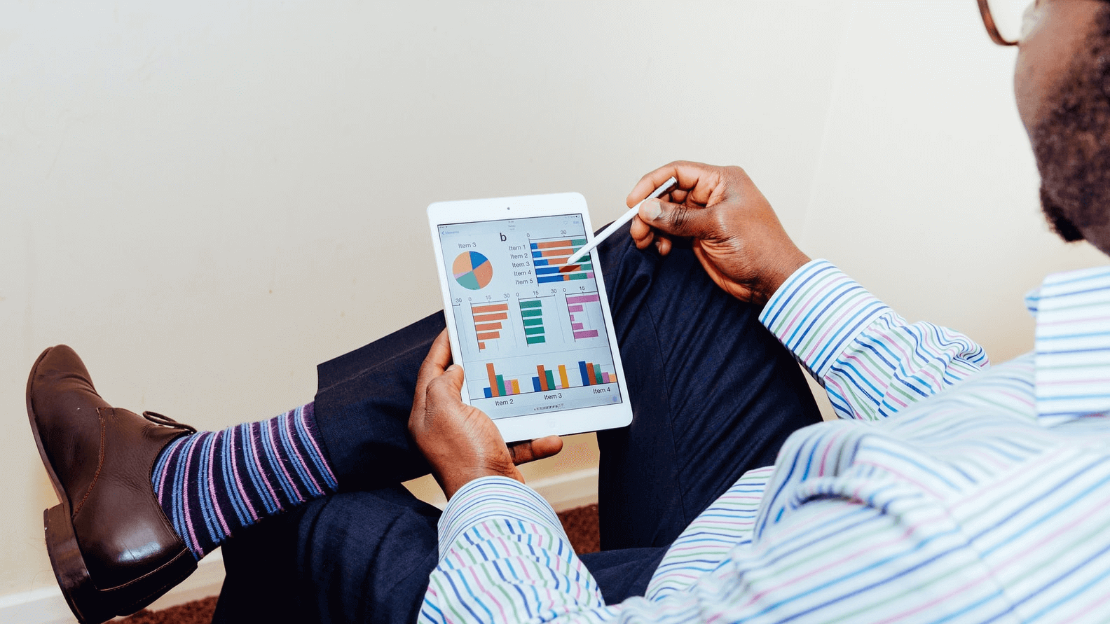 Man using tab and watching analytical data